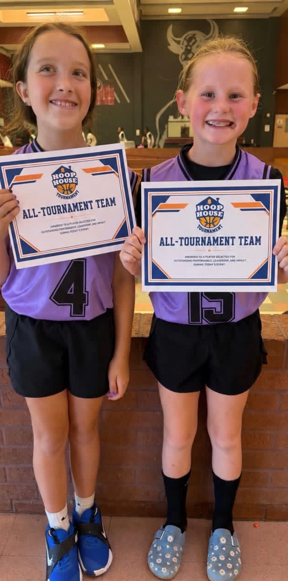 Two players holding Hoop House All-Tournament Team certificates