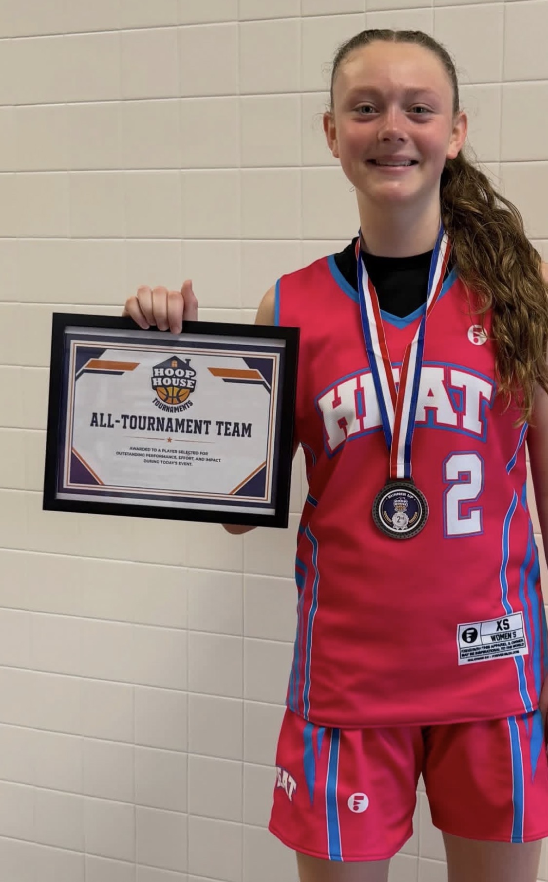 Heat player with her All-Tournament Team award and runner-up medal